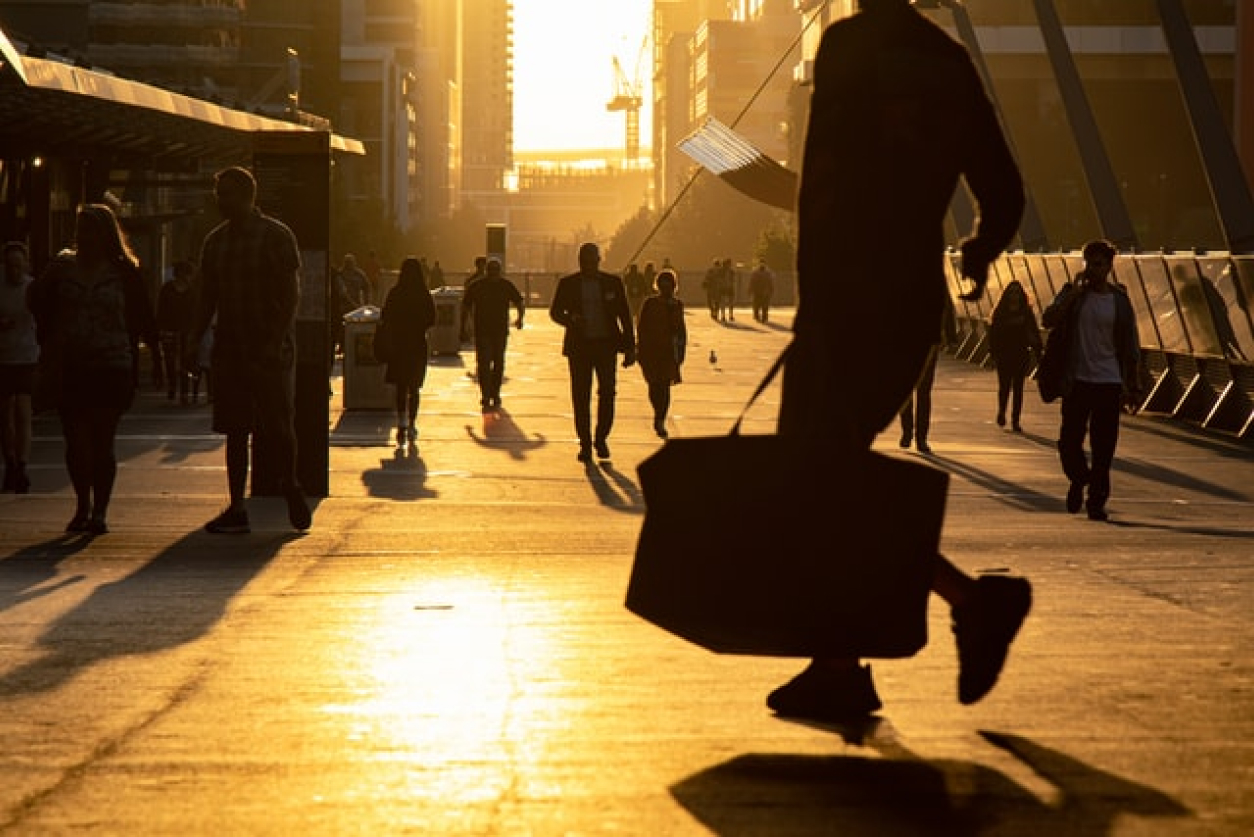 people walking in a city at dusk